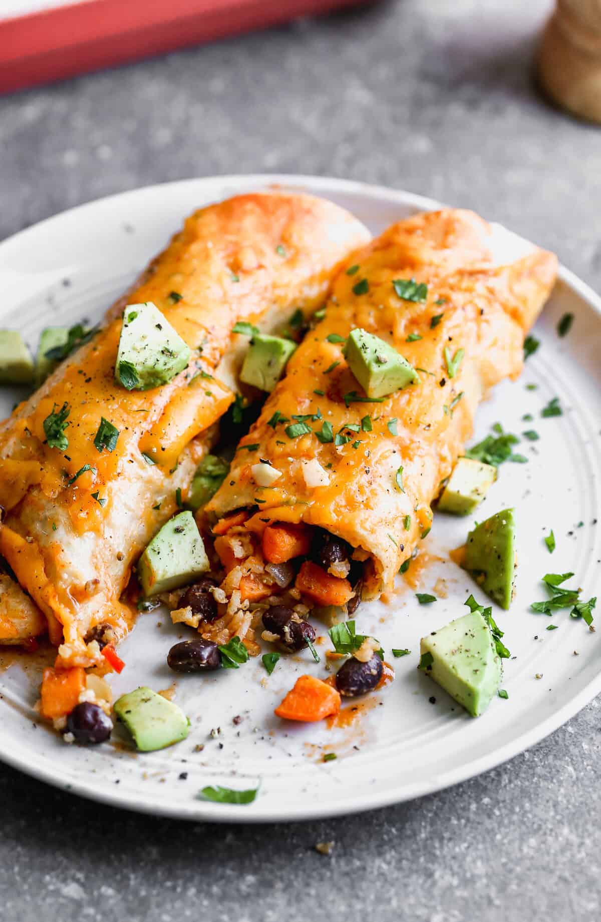 Vegetarian Enchiladas are packed with sweet potatoes, black beans, and hearty veggies for a wholesome family dinner.