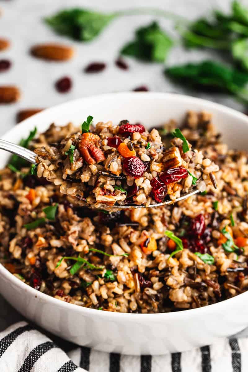 This Wild Rice Pilaf is easy to make and goes with any meal! It's flavorful and is topped with crunchy pecans and craisins.