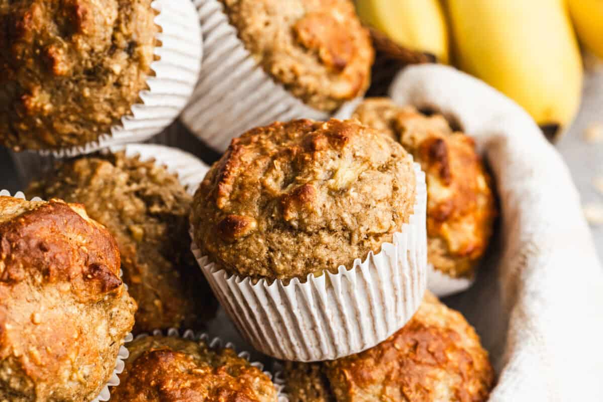 This high protein banana muffins recipe is healthy and packed with oats, bananas, greek yogurt, protein powder, and sweetened with maple syrup. They are moist, fluffy, and keep you full longer!