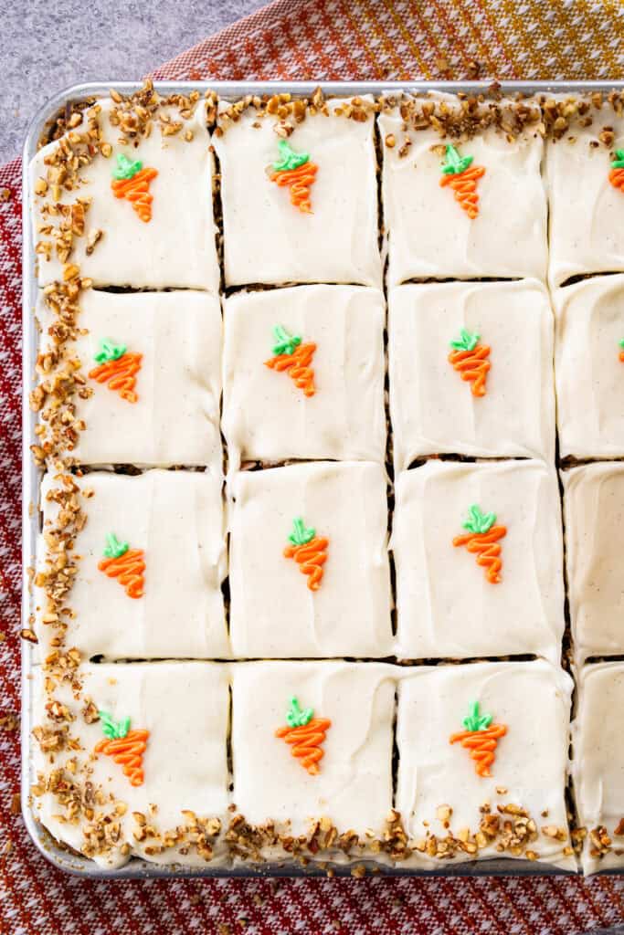 This Carrot Cake Sheet Cake recipe is tender, moist, and perfectly spiced. It's topped with a light and fluffy whipped cream cheese frosting and big enough for a crowd.