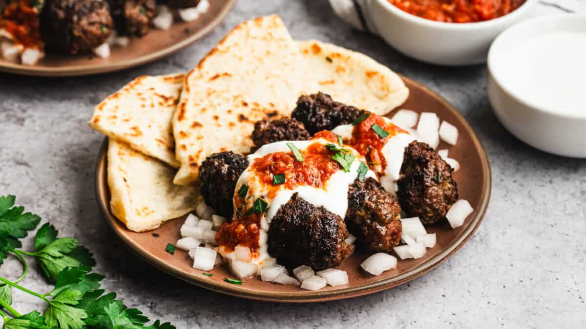 These Yogurtlu Kebabs turn ground beef into something special with creamy yogurt sauce and warm spiced tomato sauce.
