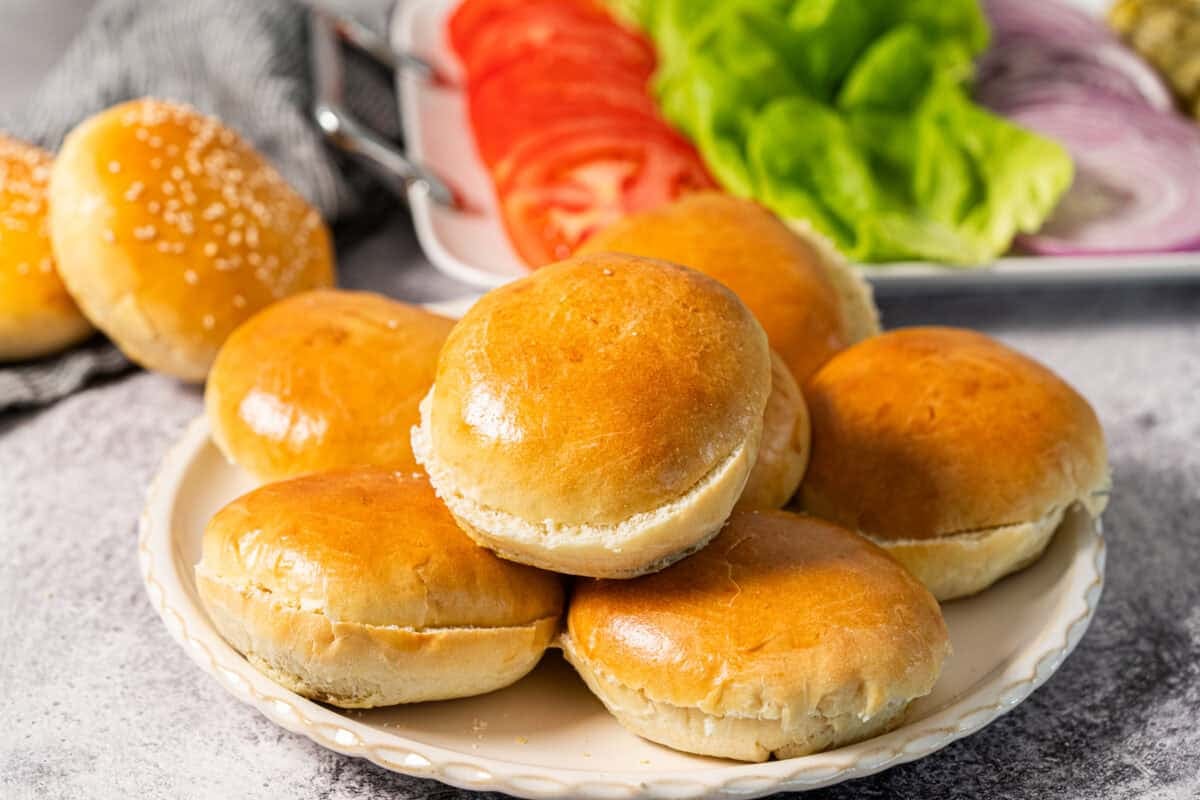 This easy Hamburger Buns recipe couldn't be easier to make and they take your average burger to something truly special. Try it once and you will never want to buy them from the store again!