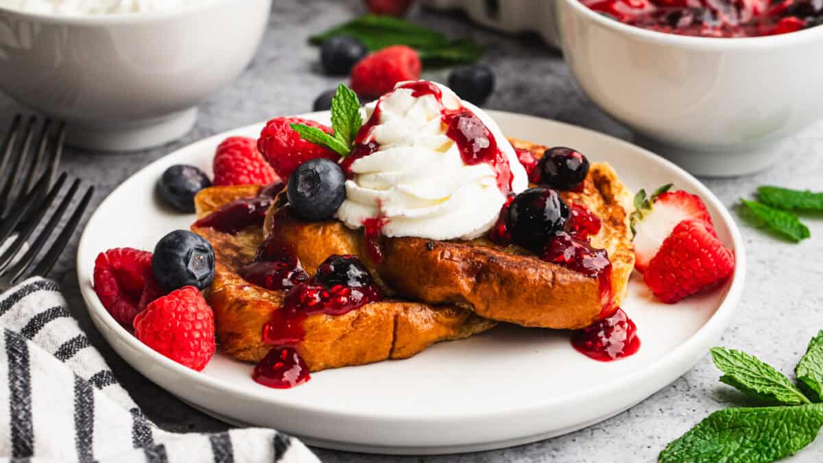 This easy Mascarpone French Toast with berries is thick, custardy brioche french toast topped with a light mascarpone whipped cream and the best fresh berry sauce. It's delicious!