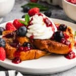 This easy Mascarpone French Toast with berries is thick, custardy brioche french toast topped with a light mascarpone whipped cream and the best fresh berry sauce. It's delicious!