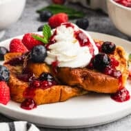 This easy Mascarpone French Toast with berries is thick, custardy brioche french toast topped with a light mascarpone whipped cream and the best fresh berry sauce. It's delicious!