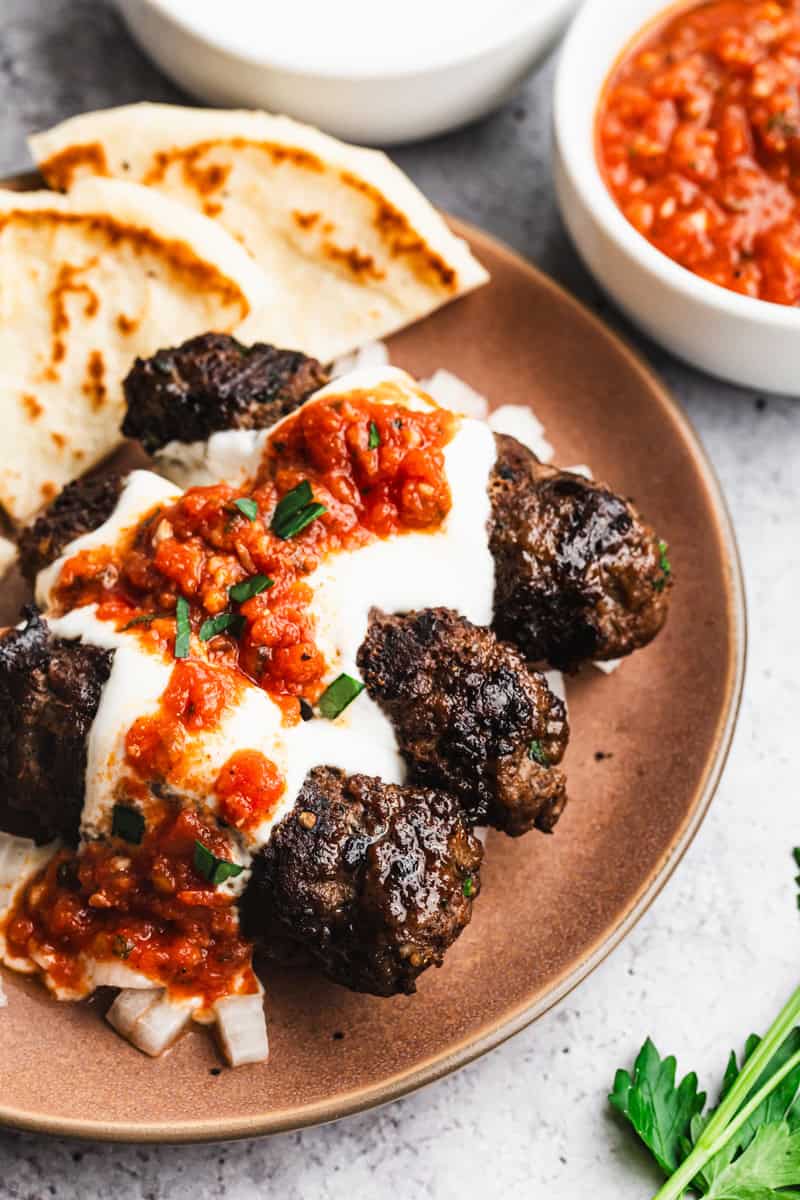 For a 4th of July meal that goes beyond the usual burgers and hot dogs, Yogurtlu Kebabs are a fun and flavorful choice.