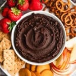 This easy Chocolate Hummus recipe is a healthier dessert that tastes just as indulgent as anything! Dip whatever fruit, crackers, or cookies you'd like for the ultimate party dip!