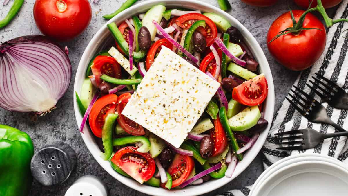 This easy Greek Salad recipe is bursting with flavor from fresh vegetables coated in a little bit of olive oil, vinegar, and seasonings. It's delicious and so quick!