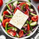 This easy Greek Salad recipe is bursting with flavor from fresh vegetables coated in a little bit of olive oil, vinegar, and seasonings. It's delicious and so quick!