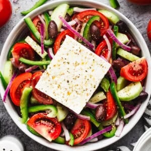 This easy Greek Salad recipe is bursting with flavor from fresh vegetables coated in a little bit of olive oil, vinegar, and seasonings. It's delicious and so quick!
