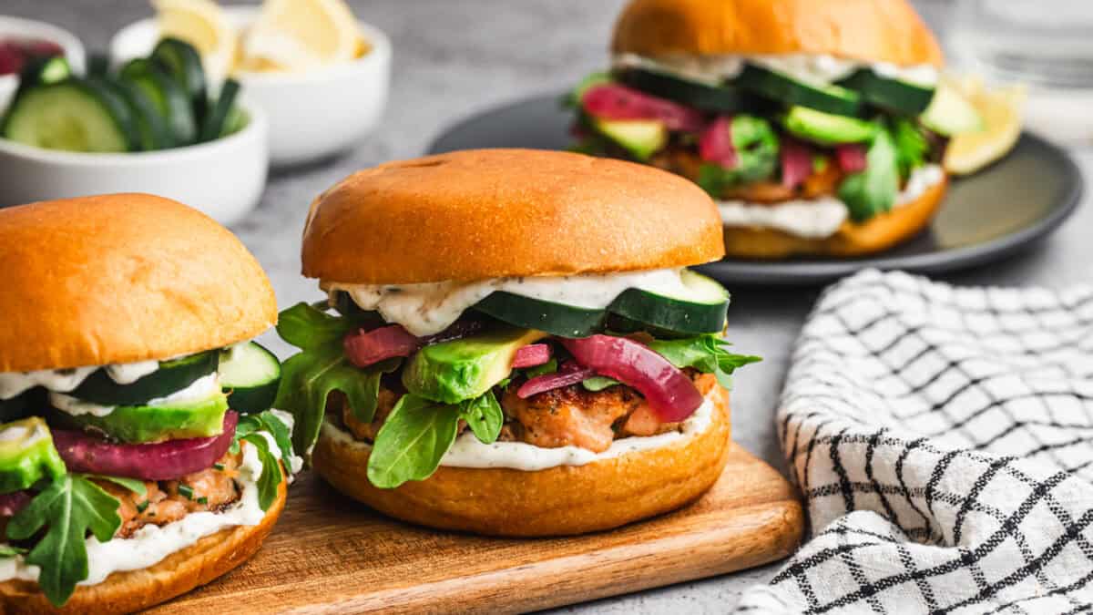 These Salmon Burgers are my new addiction made with fresh salmon and seasonings for a truly flavorful salmon patty. Top it with your favorite veggies and sauce and enjoy a new twist on burger night.