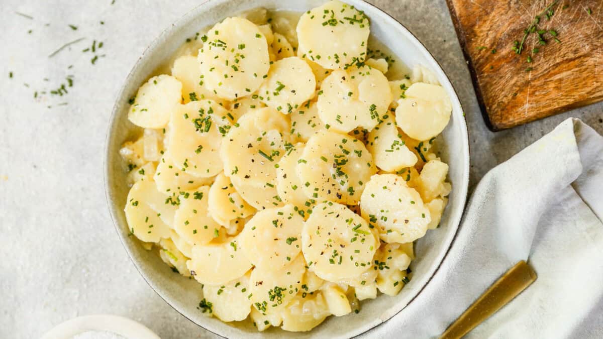 This warm German Potato Salad recipe is lightened up with no mayo and a flavorful tangy onion broth instead. It's such a delicious side dish!