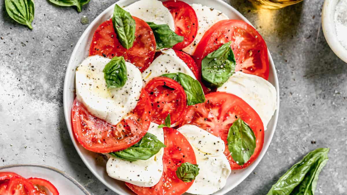 Caprese Salad only takes 5 minutes to prep, but it's an instant hit every time with slices of tomato, fresh mozzarella cheese, and basil.