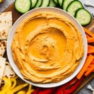 This easy Harissa Hummus recipe has a spicy kick that sets this creamy hummus apart. It's made in just 5 minutes and so delicious!