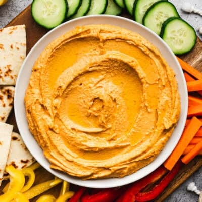 This easy Harissa Hummus recipe has a spicy kick that sets this creamy hummus apart. It's made in just 5 minutes and so delicious!