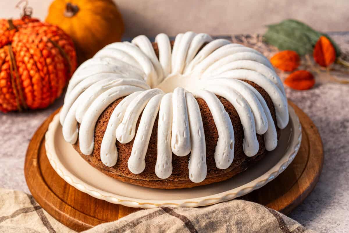 This easy Pumpkin Bundt Cake recipe is better than the bakery version and a fraction of the cost! It has the perfect Fall flavor and cinnamon cream cheese frosting.