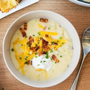 Baked Potato Soup tastes a lot better when you bake the potatoes instead of boiling them, and you're left with crispy potato dippers!