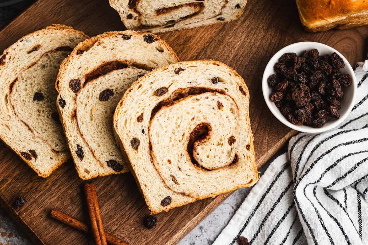This homemade Cinnamon Raisin Bread is soft, fluffy, and has sweet pump raisins throughout with a cinnamon swirl on every slice. It's easier to make than you think and so delicious!