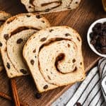 This homemade Cinnamon Raisin Bread is soft, fluffy, and has sweet pump raisins throughout with a cinnamon swirl on every slice. It's easier to make than you think and so delicious!