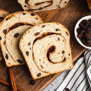 This homemade Cinnamon Raisin Bread is soft, fluffy, and has sweet pump raisins throughout with a cinnamon swirl on every slice. It's easier to make than you think and so delicious!